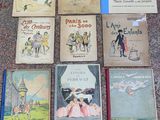 several children ' s books are lined up on the floor