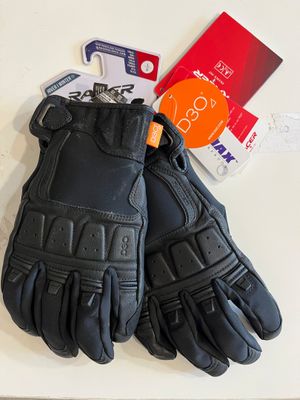 a pair of black leather gloves on a white table