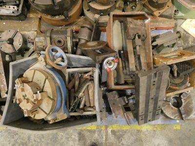 a pile of assorted metal items sitting on the floor
