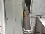 two lockers in the corner of a room with a whiteboard on the wall