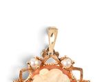an image of a gold pendant with a cameo of a woman surrounded by pearls