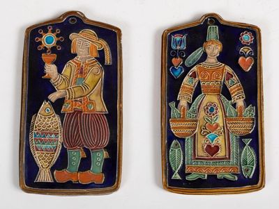 pair of ceramic plaques depicting a man and a woman holding fish