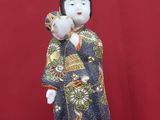 a figurine of a woman in a kimono suit