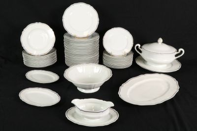 a lot of white plates and bowls on a black table