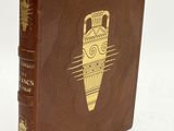 an old brown book with a gold design on the cover
