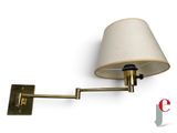 the wall lamp has a beige shade on it ' s arm