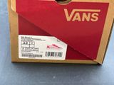 a box of vans shoes on a blue surface