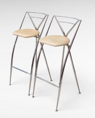 pair of chrome and leather bar stools with cross backrests