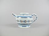 blue and white teapot with floral decoration on the rim