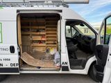 a white van with a ladder in the back of it