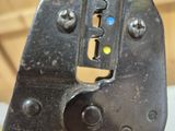 a close up of a hand holding a pliers on a table