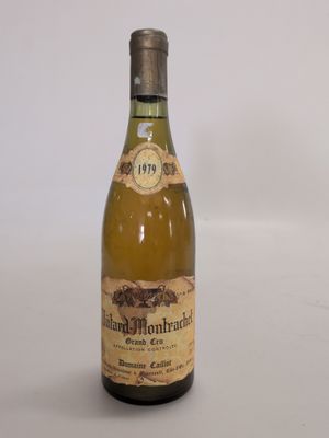 an old bottle of wine sitting on top of a white table