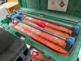 a green case with a bunch of tools inside of it