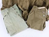 several pieces of clothing are laid out on a white surface