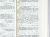 an open book sitting on top of a table next to a cup of coffee