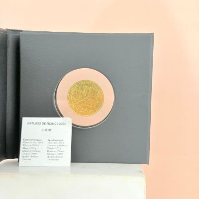 a gold coin sitting on top of a black box
