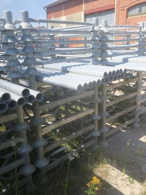 a lot of pipes that are stacked on the ground