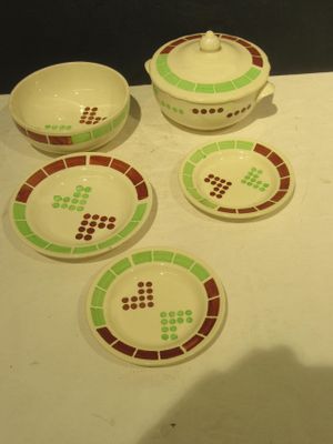four bowls and a bowl with a lid on a table