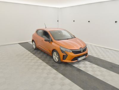 an orange car is parked in a white room with a checkered floor