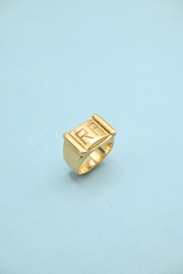 a close up of a gold ring on a blue surface