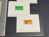 two envelopes with stamps are sitting on a table next to a book