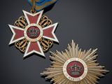 two medals and a medal on a black surface