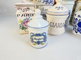 many different types of jars and containers on the table