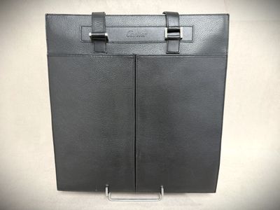 black leather briefcase with metal handles on a white background