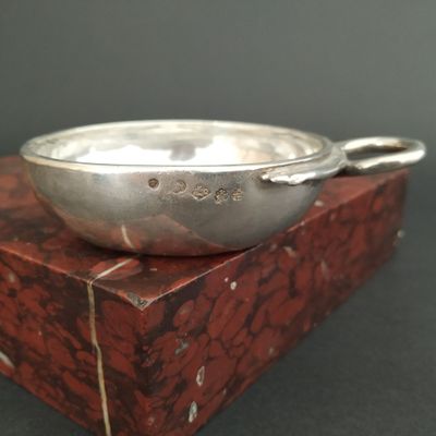 a silver bowl sitting on top of a red box