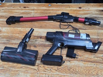 two vacuums that are sitting on a wooden table