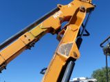 a yellow crane that is sitting on top of a pole