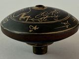 a black and gold vase with a design on it