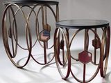 two metal tables with glass tops on a white surface