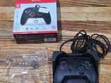 a game controller sitting on a table next to a box