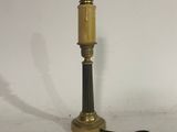 an antique brass table lamp with a black base and a black cord