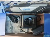 a box with a remote and a charger inside of it