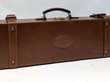 a brown suitcase that is sitting on a white surface