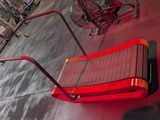 a red bench that is sitting in the middle of a gym