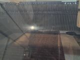 a machine that is making doughnuts on a conveyor belt