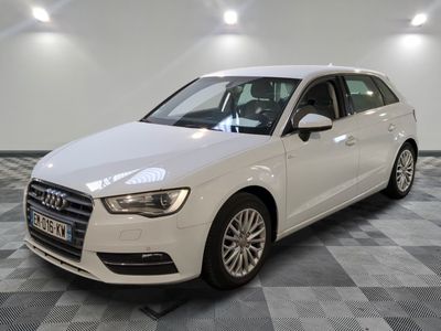 the white audi is parked in a large room with a checkered floor