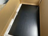 a cardboard box with a laptop in it in the middle of a room