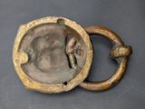 a small metal object with a handle on a table