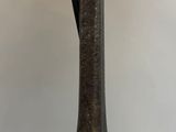 a metal sculpture of a bird on a stand