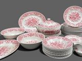 a lot of plates and bowls on the table