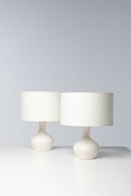 une paire de lampes de table blanches posées sur une surface blanche