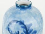 a blue and white vase sitting on a table