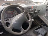 a steering wheel and dashboard of a truck with a keyboard on the dashboard