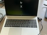 a laptop that is sitting on a desk with a keyboard