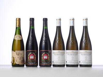 six bottles of wine are lined up on a table