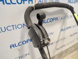 a close up of a hose connected to a wall with a sign in the background